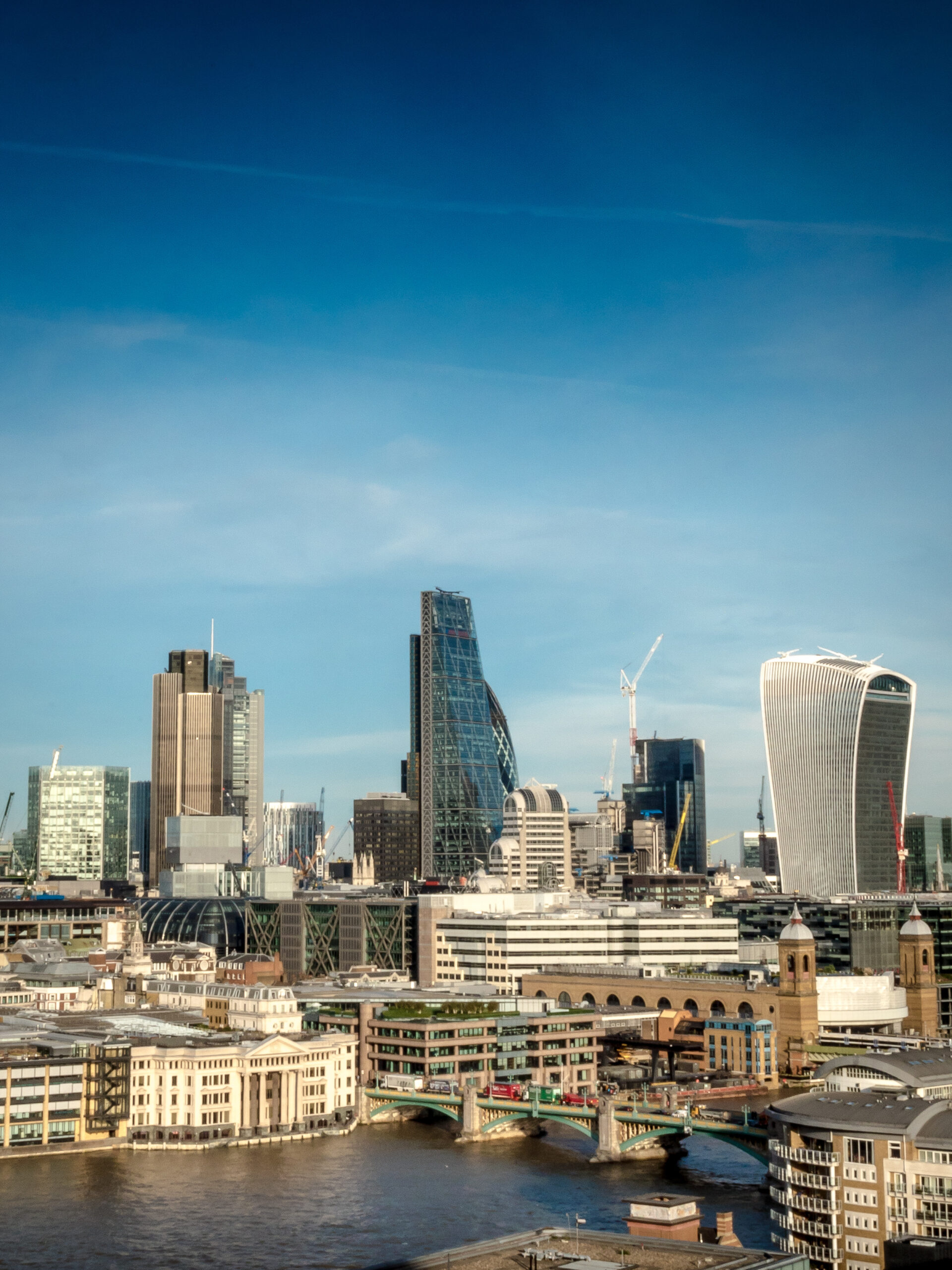 city of london. landmark skyscrapers in the financial district of the uk capital with the river thames in the foreground.